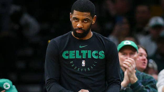 Kyrie Irving gets greeted by a camera guy as he enters TD Garden for a Sunday game against Houston.