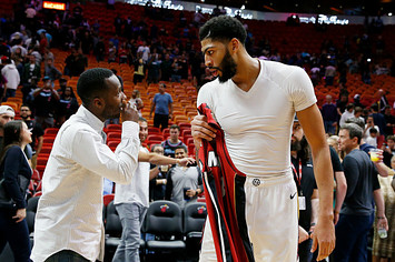 Anthony Davis #23 of the New Orleans Pelicans (left) talks with his agent Rich Paul
