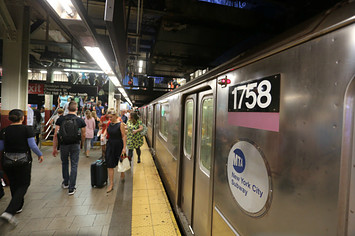People inside of the Brooklyn Bridge City Hall subway station