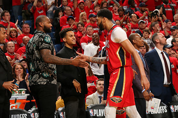 Anthony Davis #23 of the New Orleans Pelicans high fives DeMarcus Cousins #0