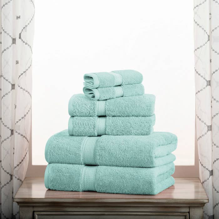 The set of six towels folded in a bathroom
