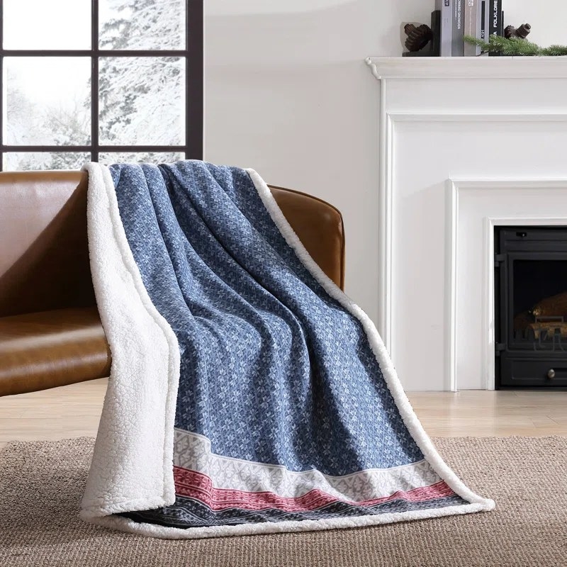 The Fair-Isle printed throw resting on a couch