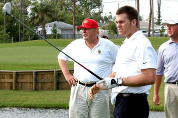 Tom Brady tees off watched by Donald Trump