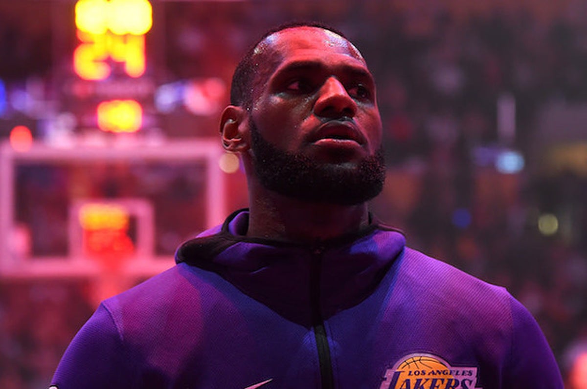 Los Angeles Lakers forward LeBron James tosses his warm up jacket