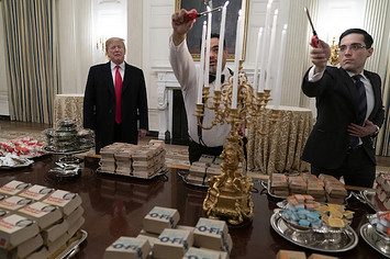 President Donald Trump presents fast food to be served to the Clemson Tigers.