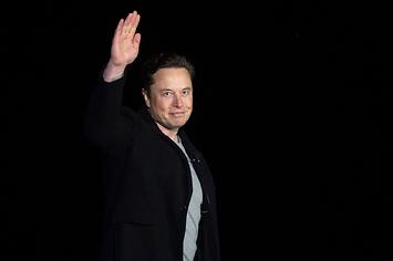 Elon Musk gestures as he speaks during a press conference at SpaceX's Starbase facility