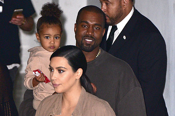 North West, Kanye West and Kim Kardashian leave Yeezy Season 2 show.
