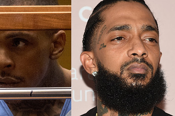 Eric Holder sits in court on trial for the murder of Nipsey Hussle, seen on the right