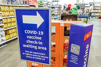 A COVID vaccine sign is seen in a store