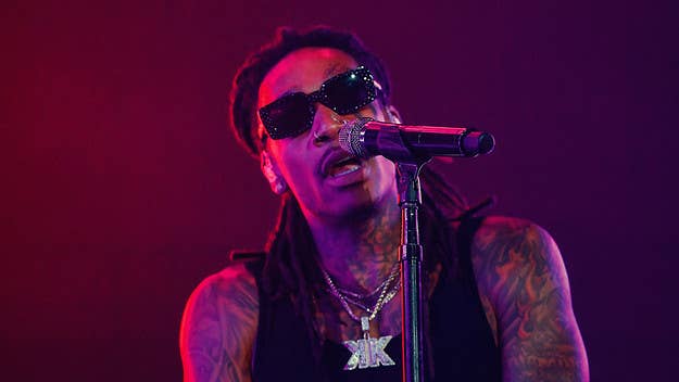 A Wiz Khalifa concert in suburban Indianapolis was halted Friday after three people were injured when people began fleeing the venue following a disturbance.