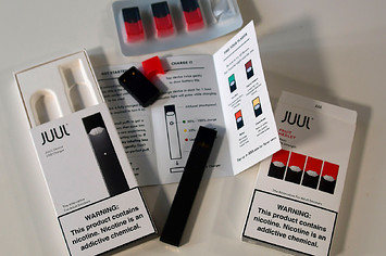 An illustration shows the contents of an electronic Juul cigarette box