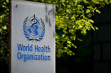 A picture taken on May 8, 2021 shows a sign of the World Health Organization (WHO) at the entrance