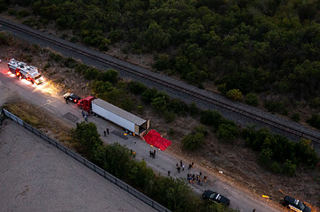 In this aerial view, members of law enforcement investigate a tractor trailer