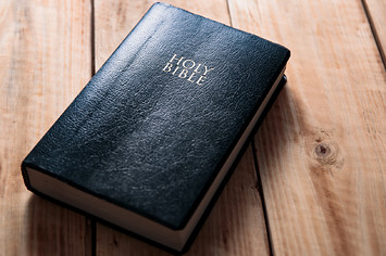 A fictional book is pictured on a wooden table