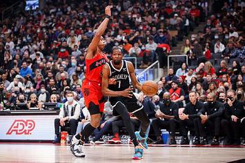 Kevin Durant #7 of the Brooklyn Nets drives on Scottie Barnes #4 of the Toronto Raptors