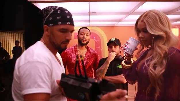 Following the release of their joyous video for “All She Wanna Do,” John Legend and Saweetie have offered a behind-the-scenes look at the shoot.