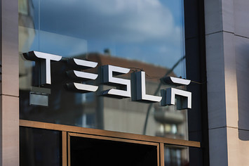 A logo for the Tesla company is shown