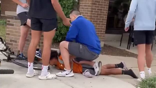 Footage shows an unidentified white man who says he’s an off-duty cop pinning down a teen, who is Puerto Rican, and accusing him of stealing his son’s bike.