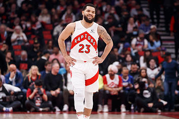 The Raptors' Fred Vanvleet smiles while standing on the court