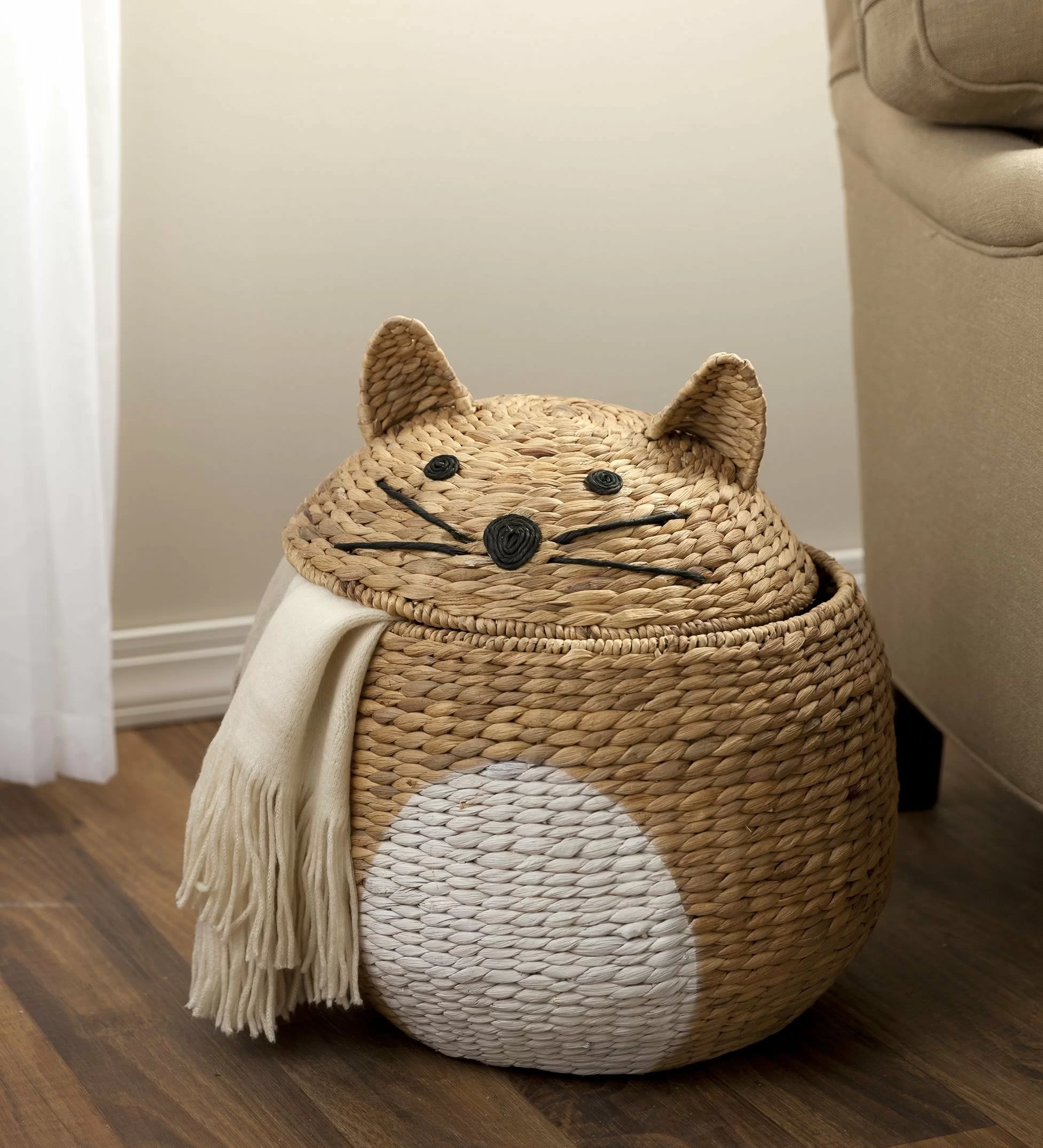 The round cat-shaped basket with ears, eyes, and whiskers