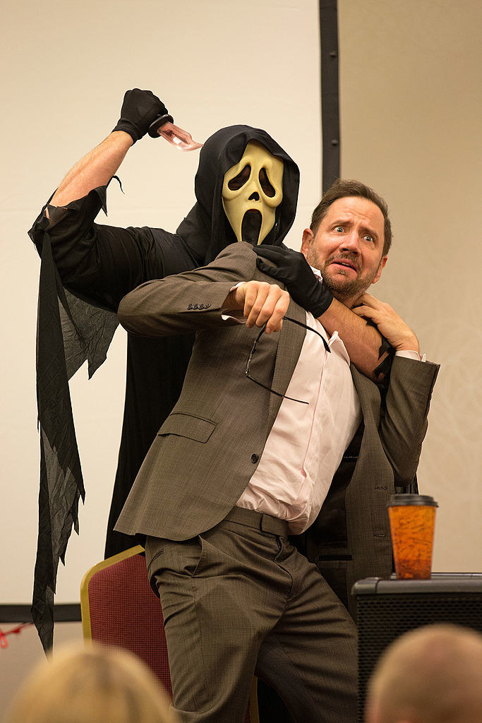 Someone in a Ghostface mask pretending to kill Jamie Kennedy
