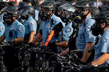 Minneapolis Police officers lined up as demonstrators protested the killing of George Floyd