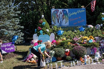 Members of the public leave flowers at a memorial site for Gabby Petito