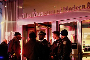 New York City police officers stand guard at the entrance of the Museum of Modern Art
