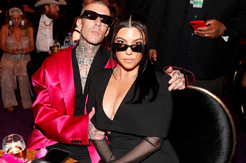 Travis Barker and Kourtney Kardashian are pictured at an event