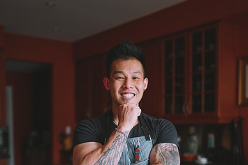 Toronto chef Wallace Wong posing in front of chef knives