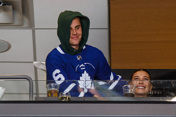 Justin Bieber wearing a Leafs jersey with his wife Hailey Bieber