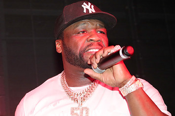 50 Cent is pictured holding a microphone