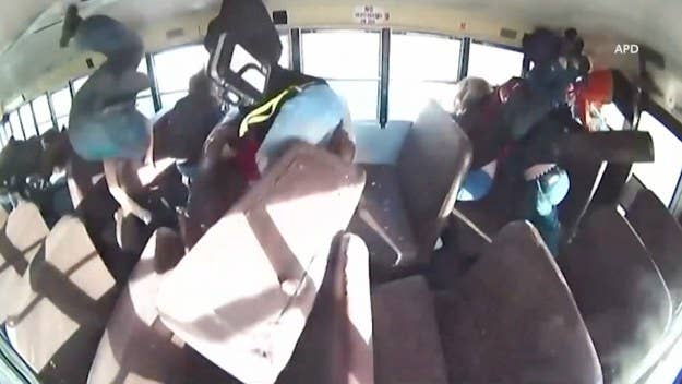 Video footage shows a man racing his white Mustang and crashing into a school bus full of children, flipping the bus and leaving two students injured.