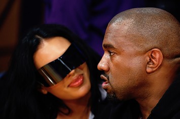 Rapper Kanye West and girlfriend Chaney Jones attend a game