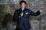 Comedian DL Hughley is pictured holding a microphone