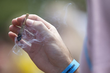 A hand is pictured holding an enjoyable marijuana cigarette