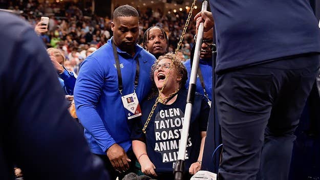 The animal rights activist was seen been carried away from the court by security. They were wearing a T-shirt that read, “Glen Taylor Roasts Animals Alive.”