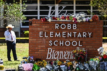 Flowers are placed on a makeshift memorial in front of Robb Elementary School in Uvalde
