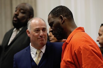 Singer R. Kelly appears standing beside his attorney, Steven Greenberg