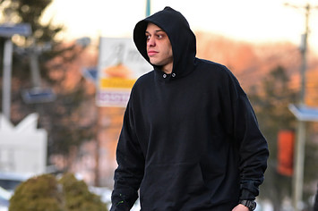 Pete Davidson is seen on a film set wearing a hoodie