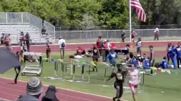 Footage of a high school track meet went viral after one of the athletes ran up and sucker-punched another in the back of the head, sending him to the ground.