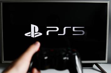 PlayStation 5 logo displayed on a tv screen and a gamepad