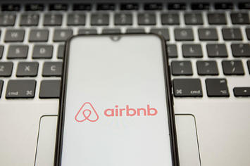 n this photo illustration an Airbnb logo seen displayed on a smartphone screen