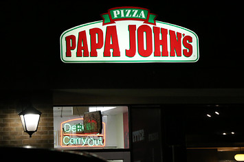 A sign for a Papa Johns pizza shop is shown