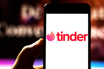 Photograph of person using Tinder app