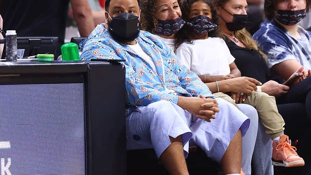 DJ Khaled was escorted back to his seat by a security guard after he walked onto the court during Sunday's game between the Hawks and Heat and shot an airball.