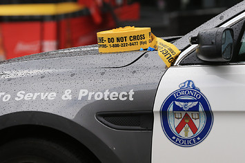 A Toronto Police Services car with caution tape sat on the hood.