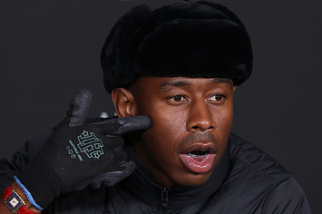 Tyler, the Creator points at his face on the red carpet
