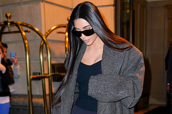 Kim Kardashian wears sunglasses in front of cameras