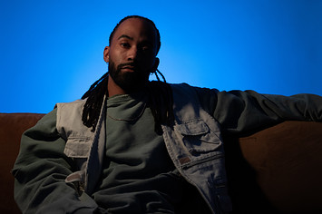 Terrell Morris sitting on a couch in front of a blue backdrop.